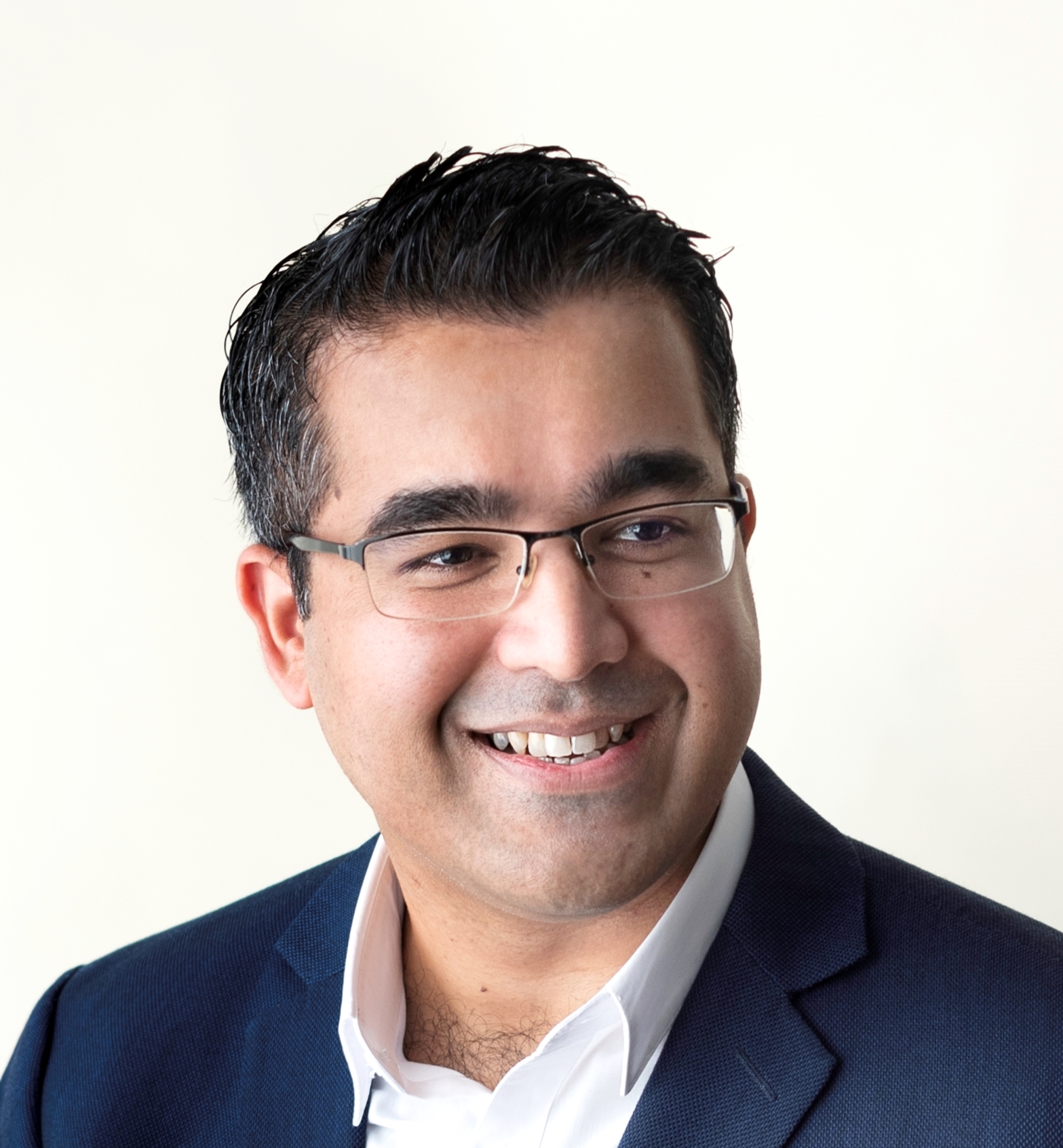 Mustafa Rasheed, Singapore-based B2B LinkedIn creator, smiling in a navy blazer
